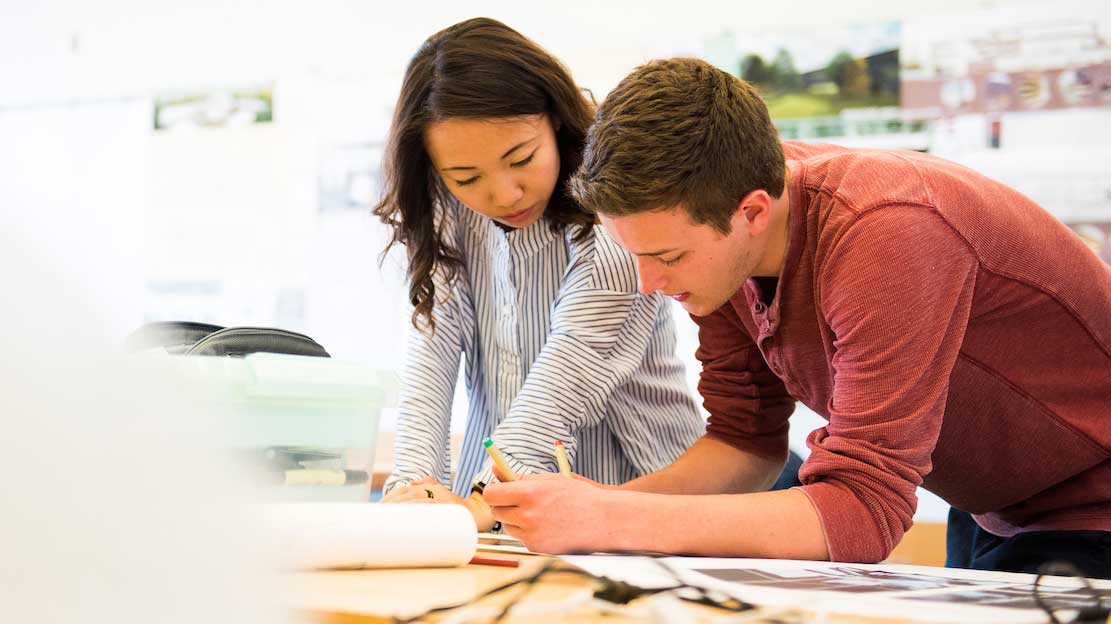 current graduate students looking over work