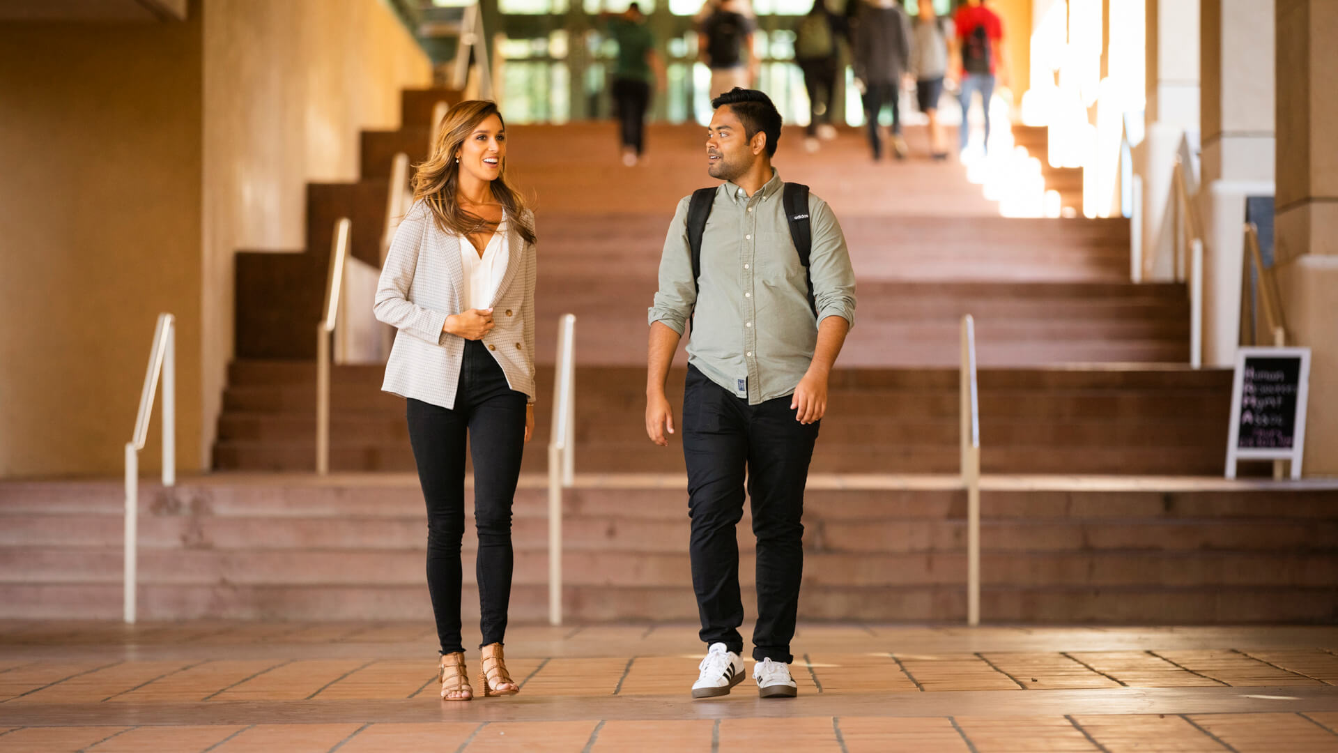 Cal Poly alumni talking with student in OCOB.