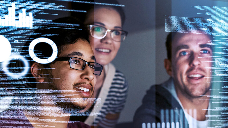 Business Analytics students looking at a computer screen