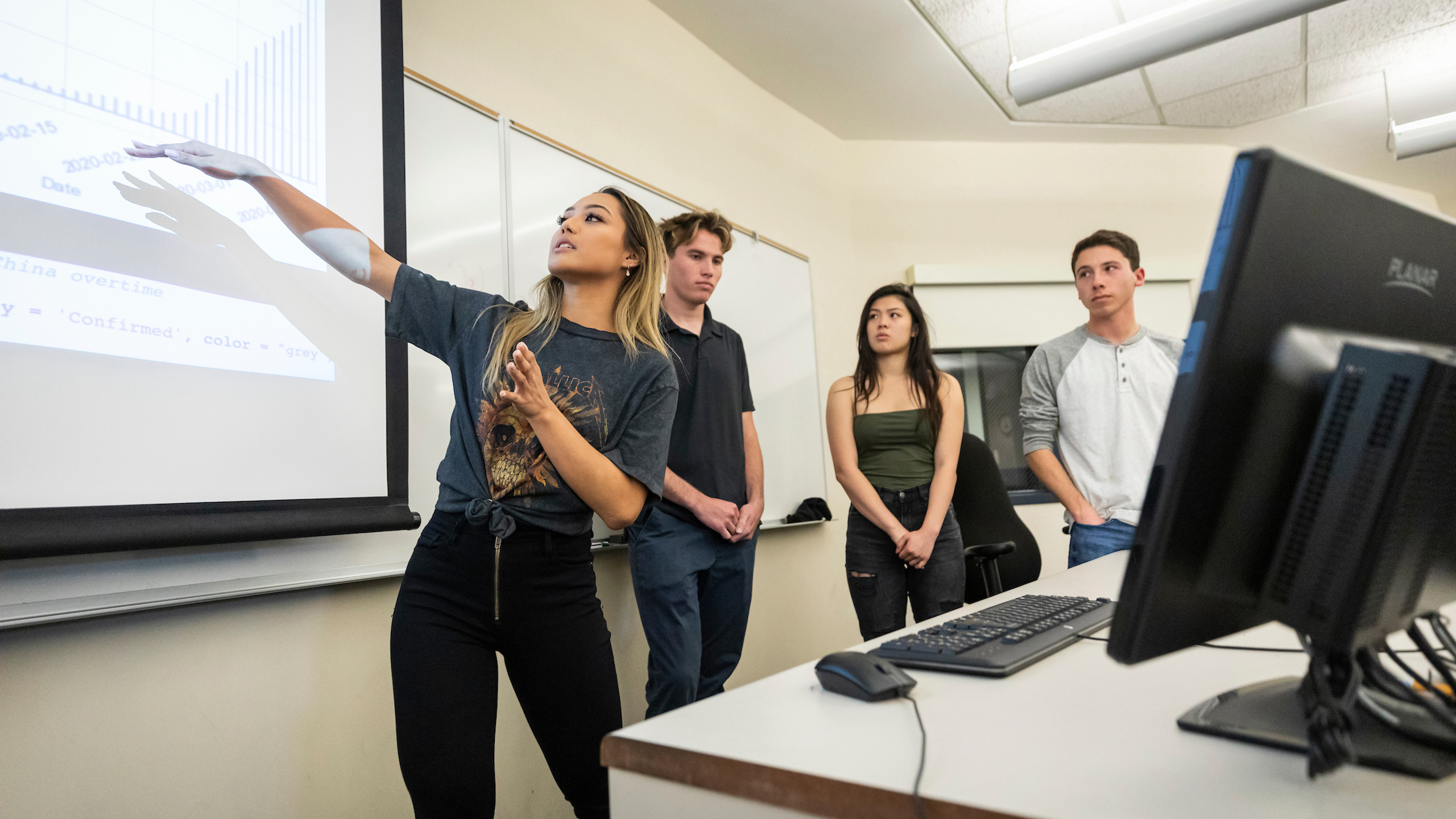 Students work on an equation on a white board